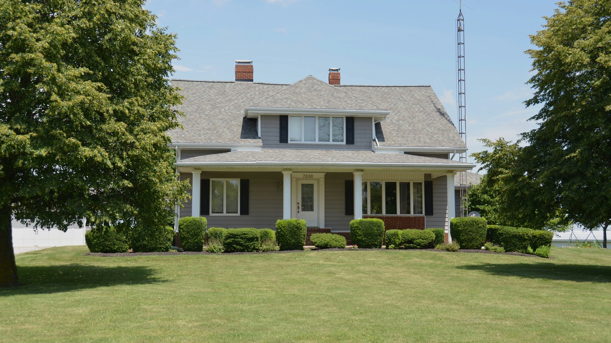 A red brick two-story house with arched windows