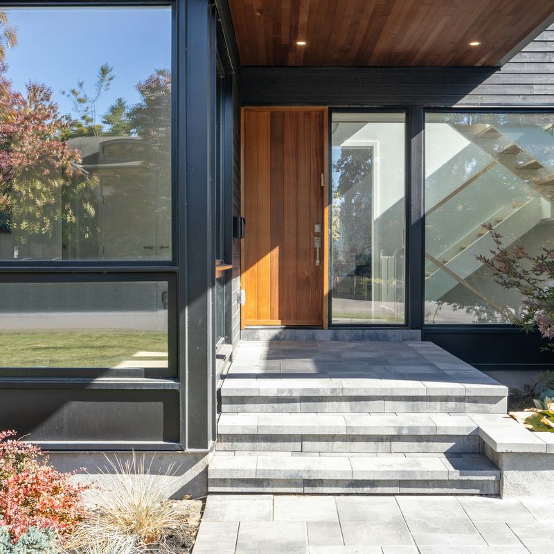 A modern front door with glass beside it